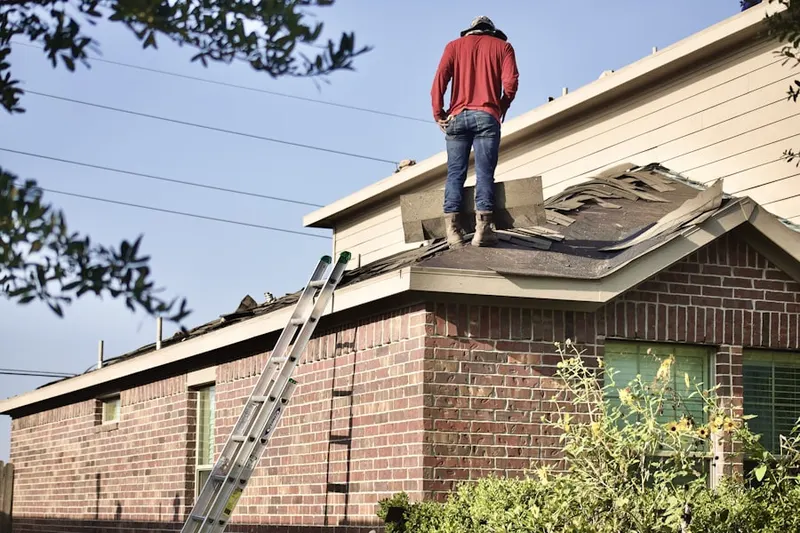 Professional roofer working on a residential roof in Westside Acres